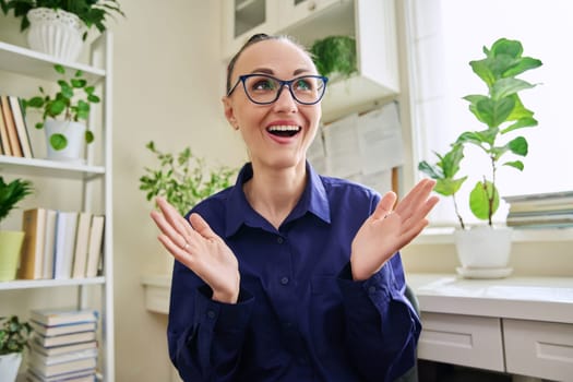 Webcam view of smiling positive 30s woman talking. Female blogger vlogger recording video, business lady during video chat conference call, teacher mentor giving online lesson, filming training course