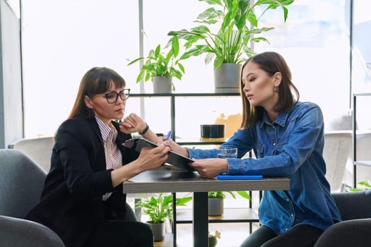 Young female patient at therapy meeting with professional psychologist, counselor, mental therapist. Psychology, psychotherapy, counseling, mental assistance, health support