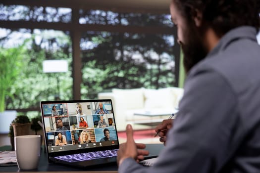 Chief executive director discusses with creditors via videocall from his luxury forest villa, engaged in web online connection for briefing meeting. Company owner presents global expansion ideas.