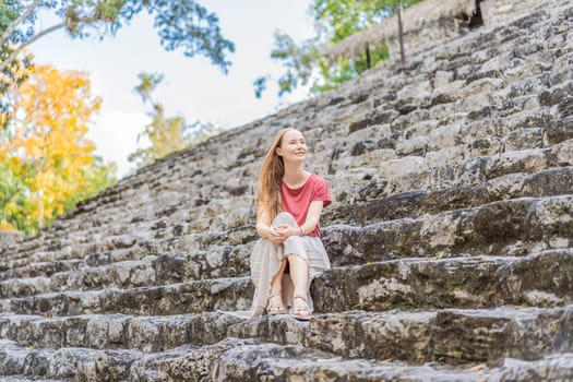 Woman tourist at Coba, Mexico. Ancient mayan city in Mexico. Coba is an archaeological area and a famous landmark of Yucatan Peninsula. Cloudy sky over a pyramid in Mexico.