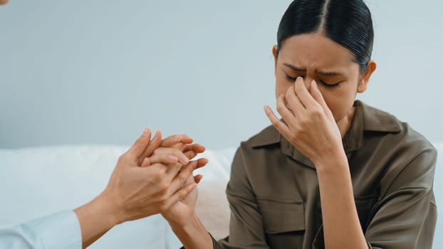 Supportive and comforting hands cheering up depressed patient person or stressed mind with empathy. Psychologist reassuring stressful and sad patient in vivancy clinic.