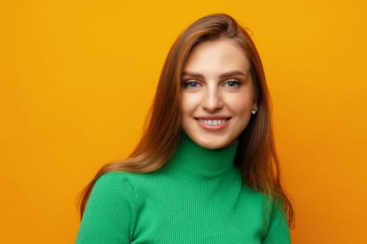 Pretty young woman smiling over yellow isolated background in studio