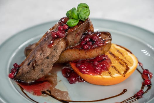 Tasty duck breast with orange and berries