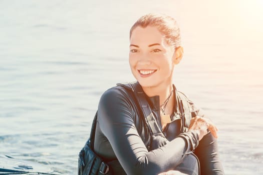 Happy smiling woman in kayak on ocean, paddling with wooden oar. Calm sea water and horizon in background