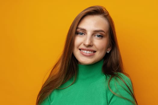 Pretty young woman smiling over yellow isolated background in studio