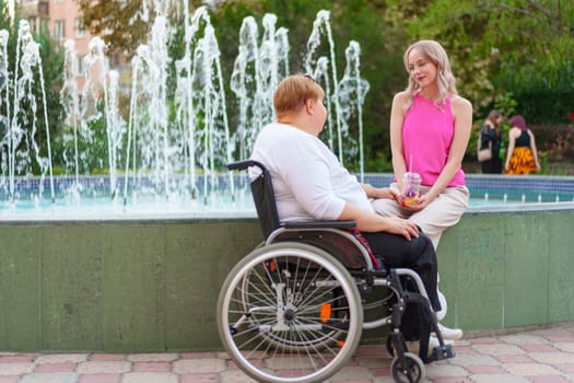 Young daughter taking care of her mother with disability sitting in wheelchair, portrait