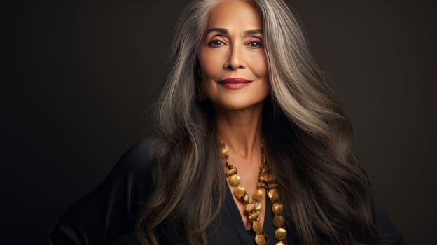 Elegant, elderly, chic latino, Spain woman with gray long hair and perfect skin, golden background, banner. Advertising of cosmetic products, spa treatments, shampoos and hair care products, dentistry and medicine, perfumes and cosmetology for women