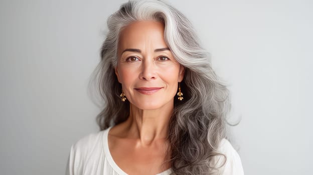 Elegant, elderly, chic Latino, Spain woman with gray long hair and perfect skin, white background, banner. Advertising of cosmetic products, spa treatments, shampoos and hair care products, dentistry and medicine, perfumes and cosmetology for women