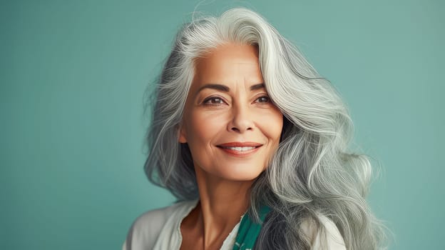 Elegant, elderly, chic latino, Spain woman with gray long hair and perfect skin, green background, banner. Advertising of cosmetic products, spa treatments, shampoos and hair care products, dentistry and medicine, perfumes and cosmetology for women