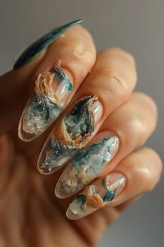 A closeup of beautifully designed nails with nail polish. This manicure service enhances the natural beauty of fingers and thumbs with cosmetic art