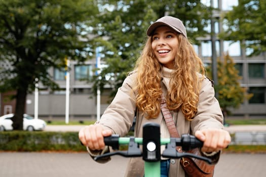 Young woman standing on electric scooter in the city, close up