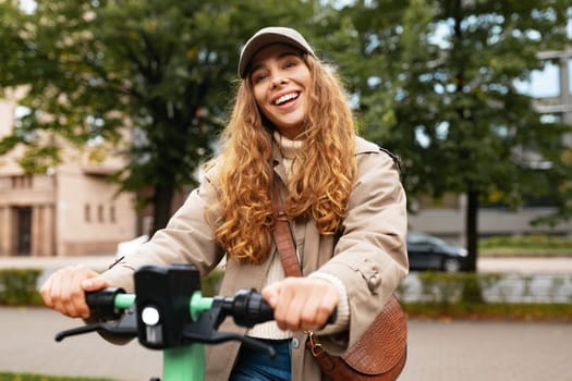 Young woman standing on electric scooter in the city, close up