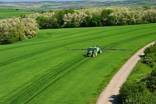 Tractor on the field. Concept for agriculture and nature. Czech Republic.