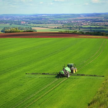 Tractor on the field. Concept for agriculture and nature. Czech Republic.