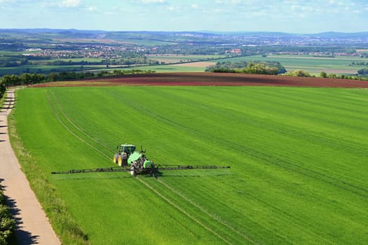 Tractor on the field. Concept for agriculture and nature. Czech Republic.