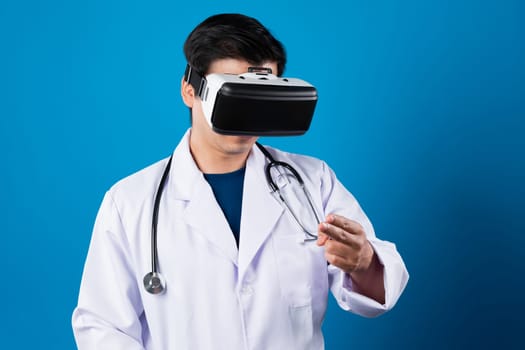 Smart doctor wearing VR headset connect metaverse touching screen with medicine research treatment futuristic tech hologram virtual reality intelligent meta world isolate blue background. Contrivance.