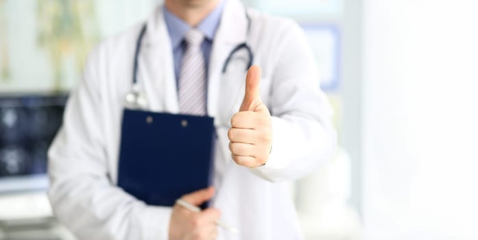 Male doctor show thumb up sign as public opinion expression for good treatment closeup