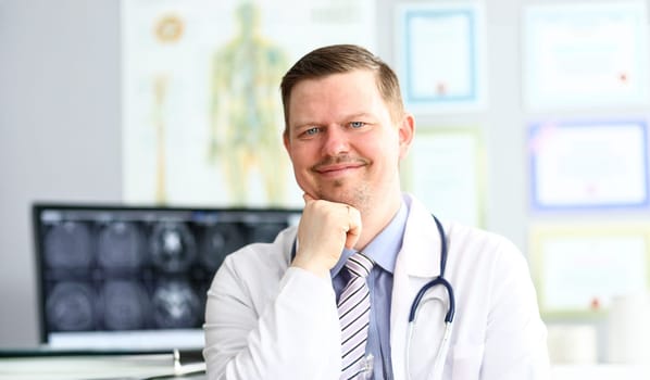 Adult smiling gp looking in camera in office portrait