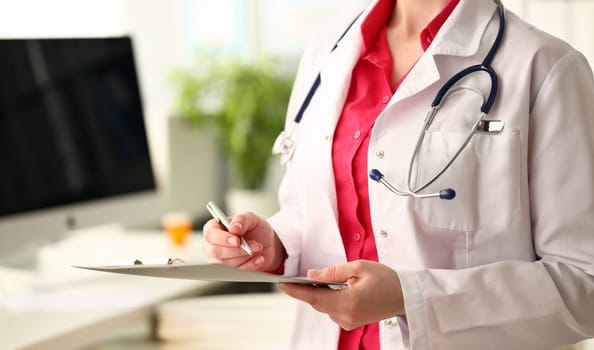 Woman Doctor with Clipboard to Write Prescription. Medic Female with Stethoscope Hold Silver Pen in Hand. Doc Physician Filling Medical Form. Medicine Recipe for Treatment Closeup Photography