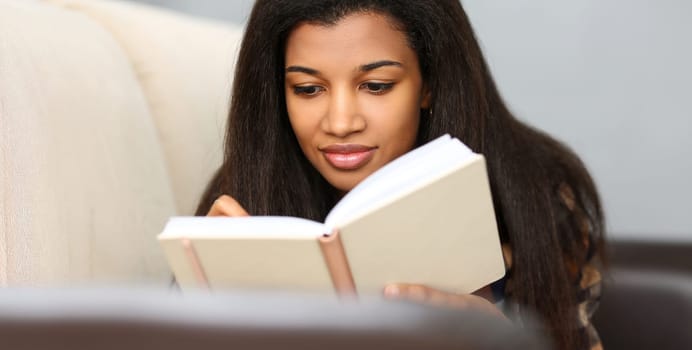 Smiling black woman write story in notebook preparing for college