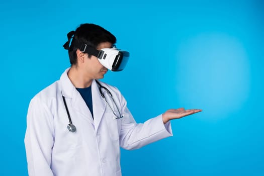 Smart doctor wearing VR headset looking to connect metaverse data holding analytical medicine research isolated blue background futuristic technology hologram virtual reality meta world. Contrivance.