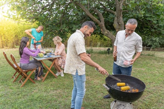 Family around the barbecue together. High quality photo