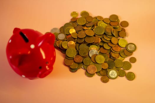 A red piggy bank full of coins. High quality photo