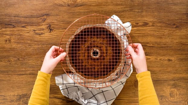 Flat lay. The gingerbread bundt cake gently eases out of its mold onto a wire rack, poised for a drizzle of sweet caramel frosting.