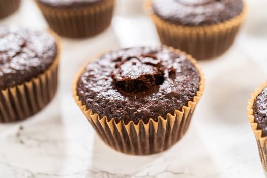 Each chocolate cupcake receives a generous filling of luscious caramel, adding an extra layer of flavor and indulgence.