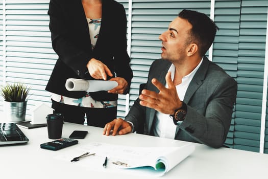 Businessman executive checking work while meeting discussion with businesswoman worker in modern workplace office. People corporate business team concept. uds