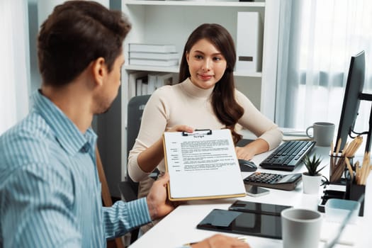 Beautiful woman hand over script note to manager for reviewing message on interesting topic creativity channel on broadcast before streaming live with advertise business at modern office. Postulate.