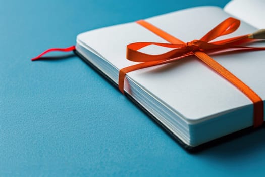 Traveler's companion white notebook with orange ribbon on blue background