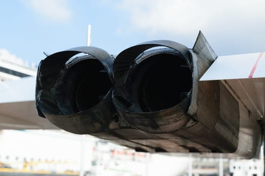 Close-up of the twin jet engines of an aircraft, showing the exhaust nozzles and surrounding structure.