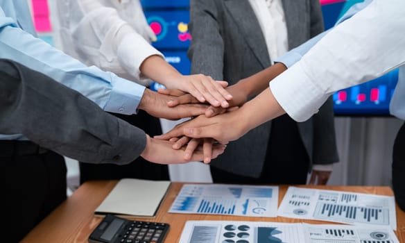 Multiracial office worker's hand stack shows solidarity, teamwork and trust in diverse community. Businesspeople unite for business success through synergy and collaboration by hand stacking. Concord