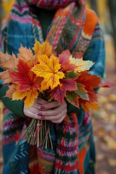 woman holds autumn leaves in her hands. Selective focus. nature.