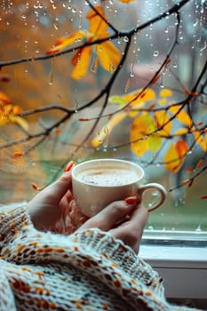 A cup of tea against the background of a wet autumn window. Selective focus. drinks.