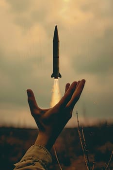 A man's hand holds a rocket. Selective focus. Nature.