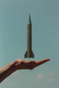 A man's hand holds a rocket. Selective focus. Nature.