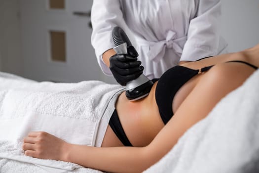 Client undergoes vacuum to facilitate removal of liquefied fat cells. Salon provides aesthetic techniques to achieve slimmer abdominal profile