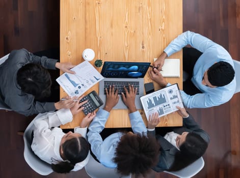 Top view multiracial analyst team use BI dashboard display on laptop screen, analyzing financial data for strategic decision. Fintech analyzes marketing indicators. Concord