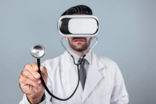 Skilled doctor wear VR glasses and lab coat while hold stethoscope for diagnosis disease. Caucasian doctor looking medical data from virtual reality goggles device. Innovation technology. Deviation.