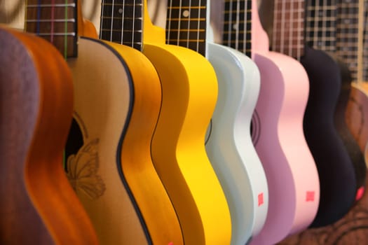 Row of colorful guitars hanging ,