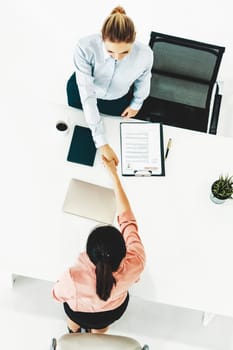 Two young business women in meeting at office table for job application and business agreement. Recruitment and human resources concept. uds