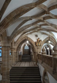 Munich, Germany - Dec 21, 2023 - Gothic architectural style with arches of famous New Town Hall (Neues Rathaus) on Marienplatz square in Munich. Beautiful Corridor with Staircase, Ceiling, Pillars and Lamp, Space for text, Selective focus.