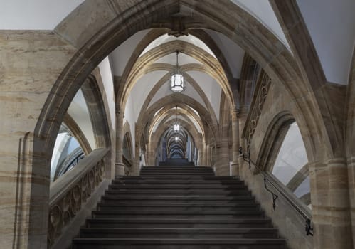 Munich, Germany - Dec 21, 2023 - Gothic architectural style with arches of famous New Town Hall (Neues Rathaus) on Marienplatz square in Munich. Beautiful Staircase with Ceiling, Pillars and Lamps, Space for text, Selective focus.