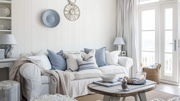 Interior of a living room with white walls, sofa and cushions. Sitting room in coastal cottage with sea view. Luxury lounge room