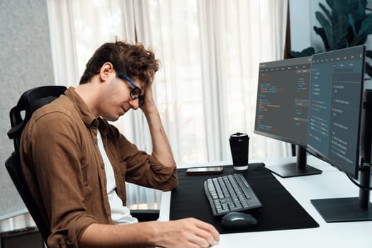Working IT developer with stressful overworked in creating coding on pc screen in latest version application on website online in big project, having headache in bad feeling at home office. Gusher.