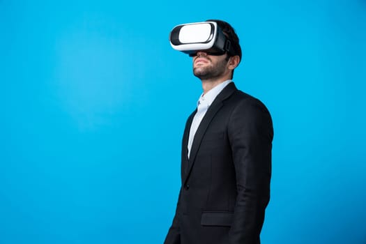 Skilled project manager with VR glasses standing and looking around. Caucasian businessman connecting with metaverse and virtual reality world while wearing suit. Innovation technology. Deviation.