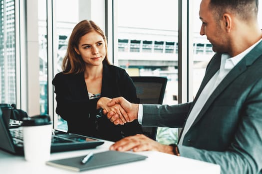 Businessman executive handshake with businesswoman worker in modern workplace office. People corporate business deals concept. uds