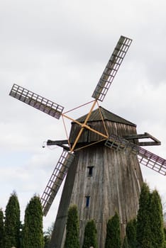 Old wooden wind mill in on sunny day. Old traditional Dutch mill.